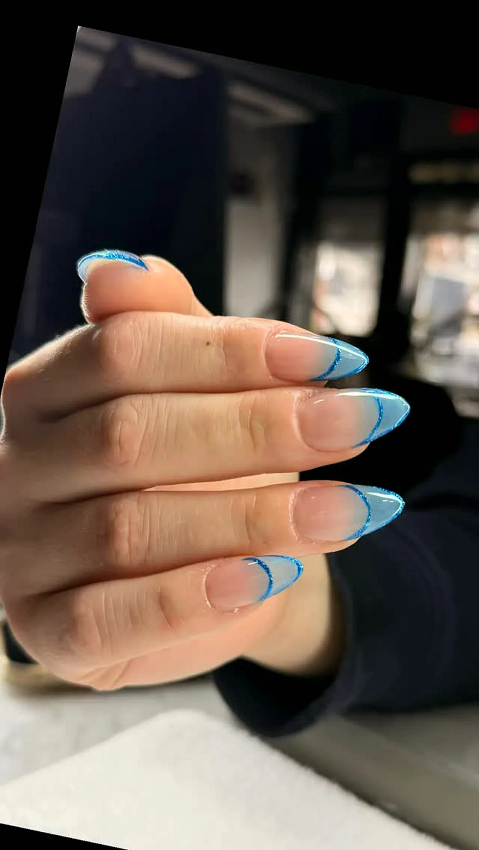 Nude almond nails with light blue French tips done at Attraction Nails Salon in Roselle Park, NJ