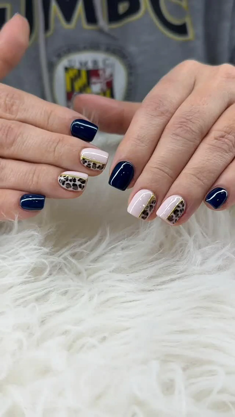 Navy blue and white nails with leopard print accent nails done at Attraction Nails Salon in Roselle Park, NJ