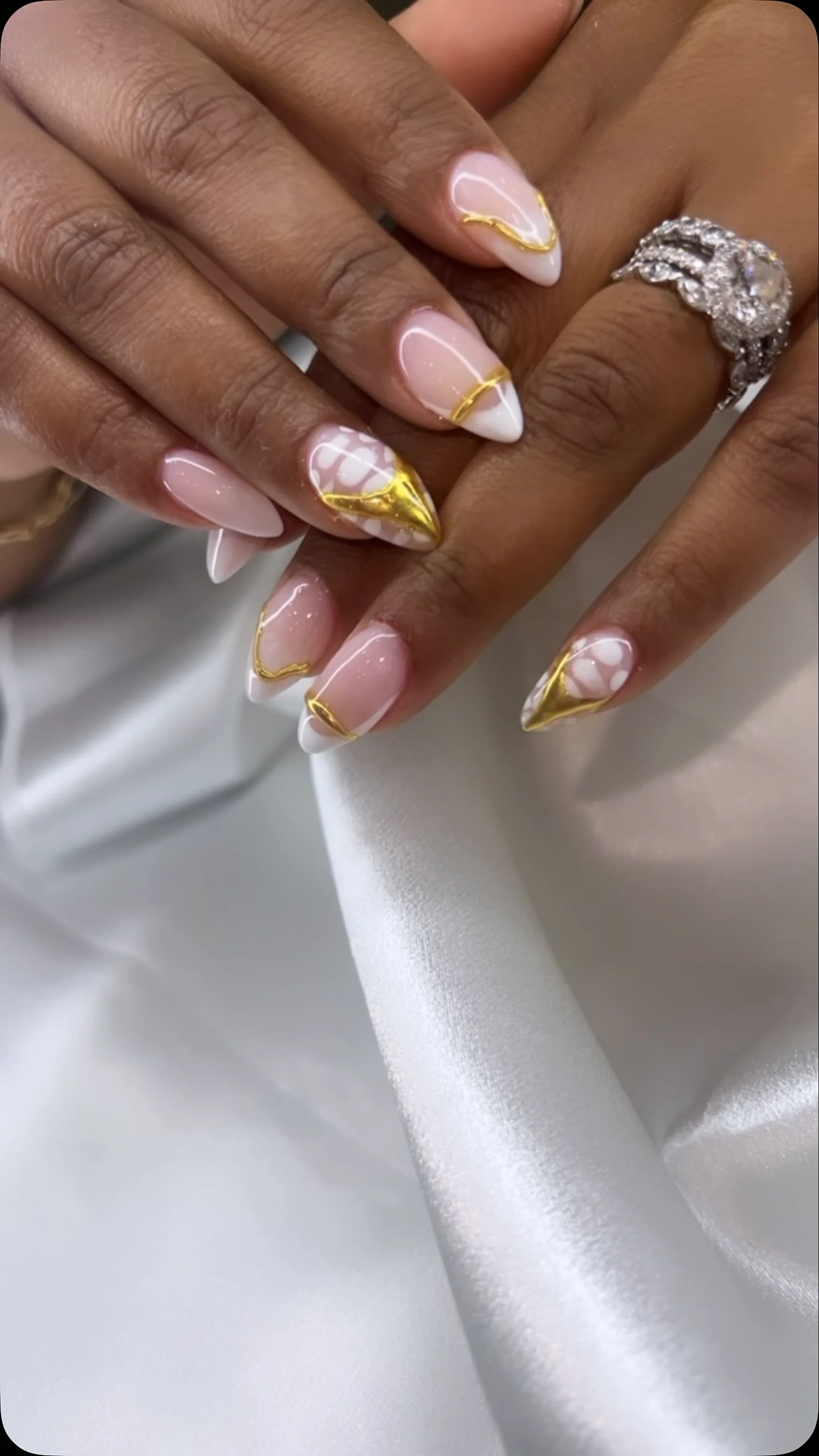 Nude almond nails with gold foil French tips done at Attraction Nails Salon in Roselle Park, NJ