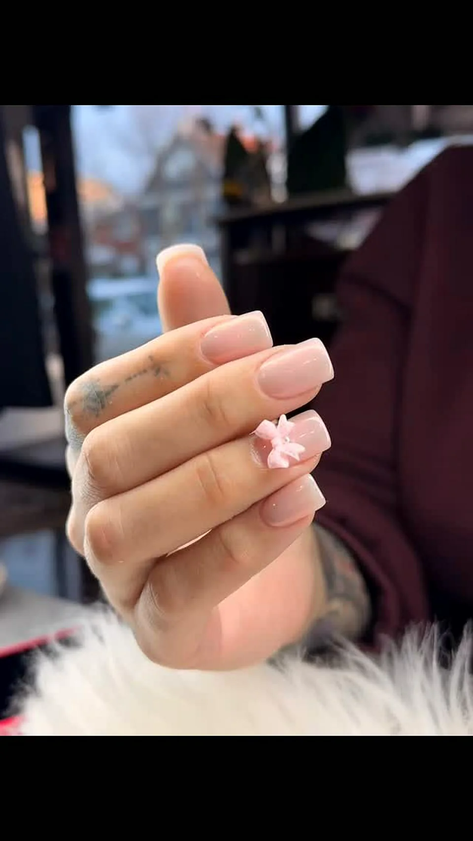 Long nude coffin extensions with a sculpted pink 3D bow, Attraction Nails Salon Roselle Park NJ