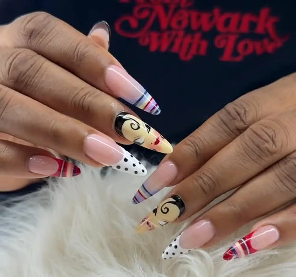 Pop-art nail design with hand-painted faces and polka dots done at Attraction Nails Salon in Roselle Park, NJ