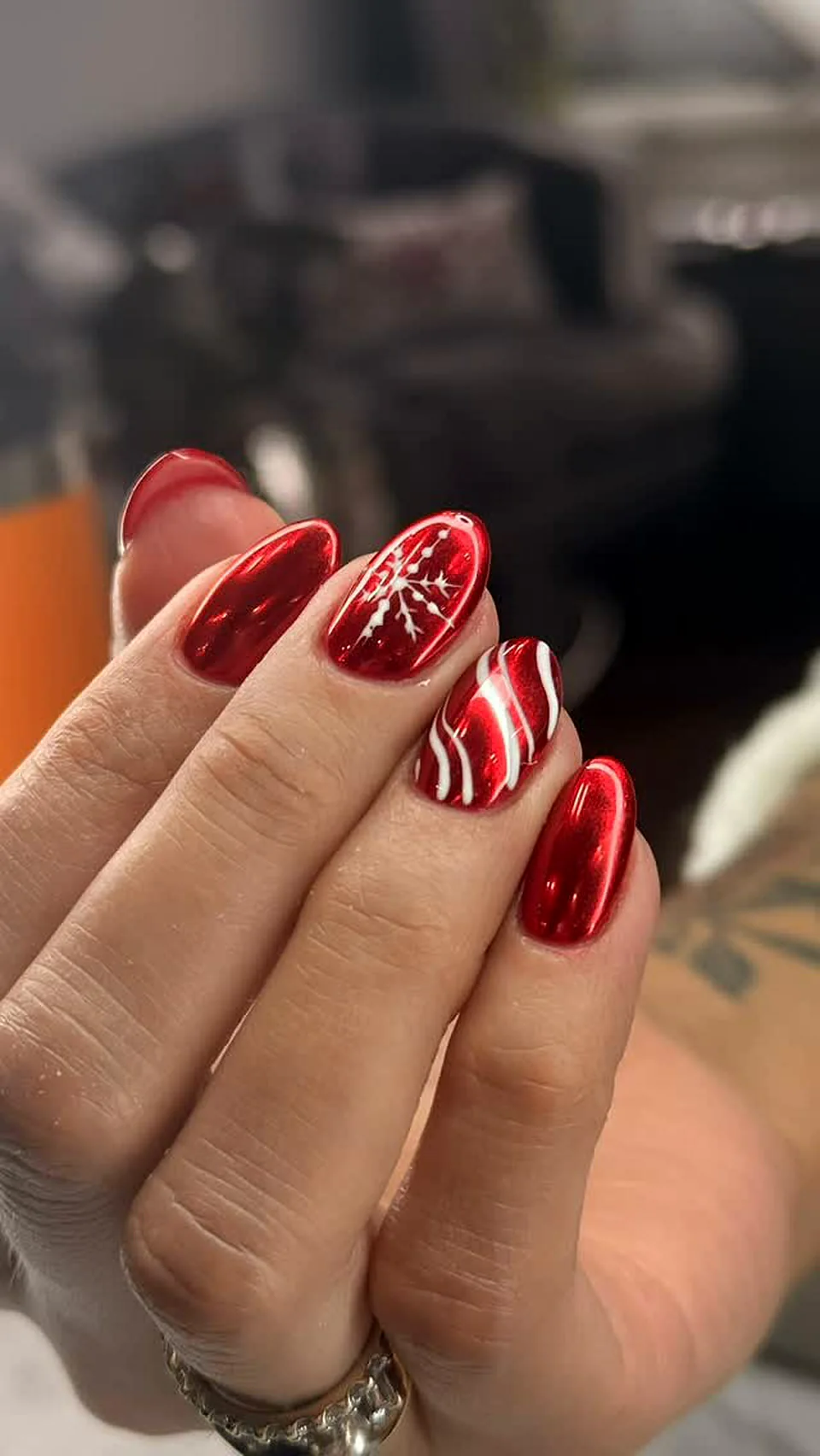 Red chrome nails with candy cane stripes for the holidays done at Attraction Nails Salon in Roselle Park, NJ