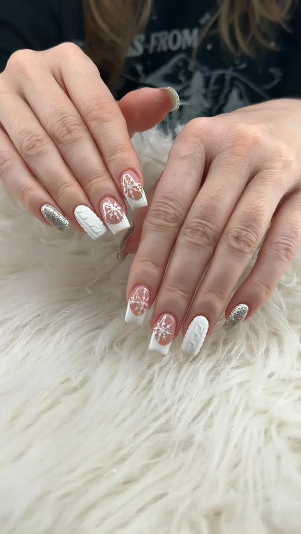 White and nude nails with hand-painted snowflakes done at Attraction Nails Salon in Roselle Park, NJ