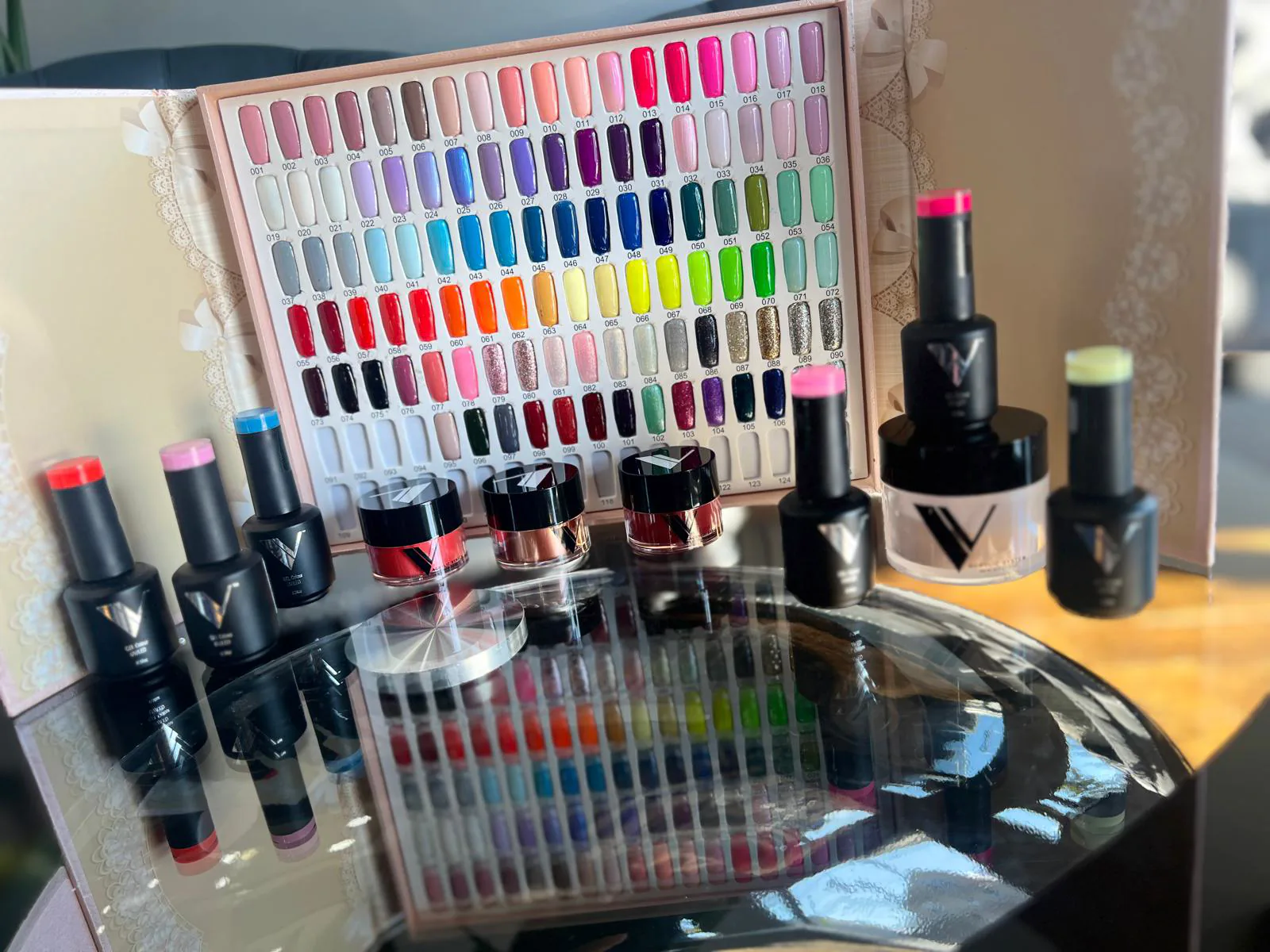Gel color swatch display and polish bottles at Attraction Nails Salon