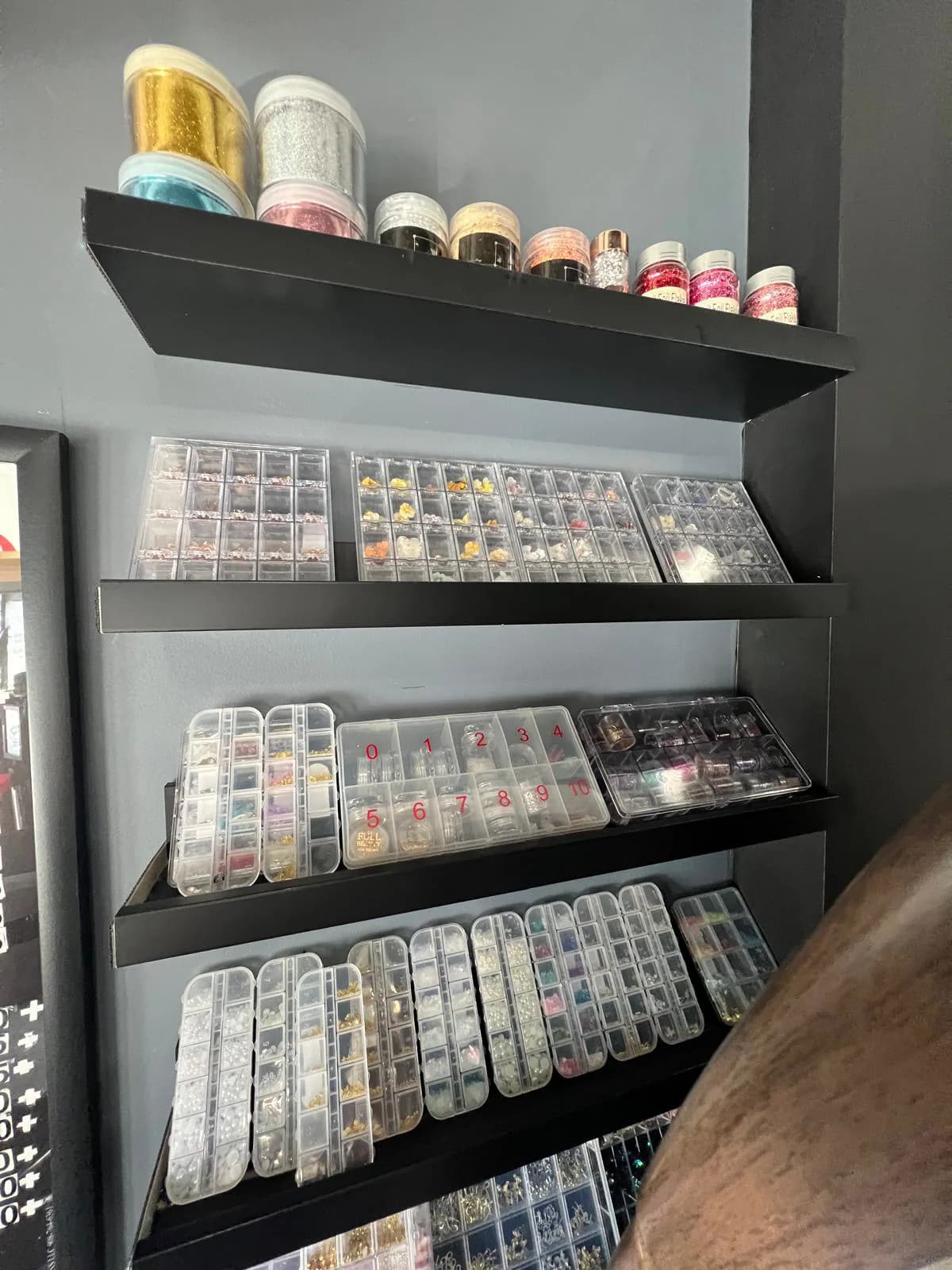 Nail tip shapes and powder display at Attraction Nails Salon