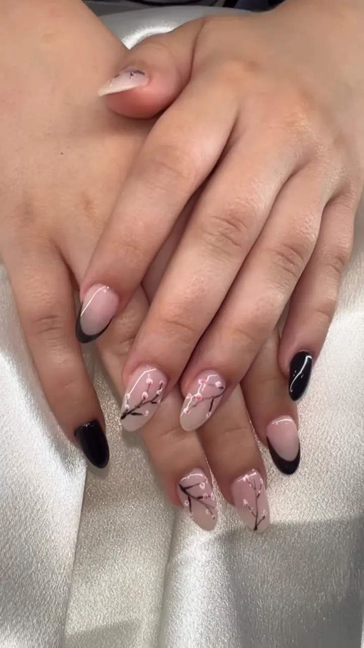 Video of nude almond nails with black tips and line art