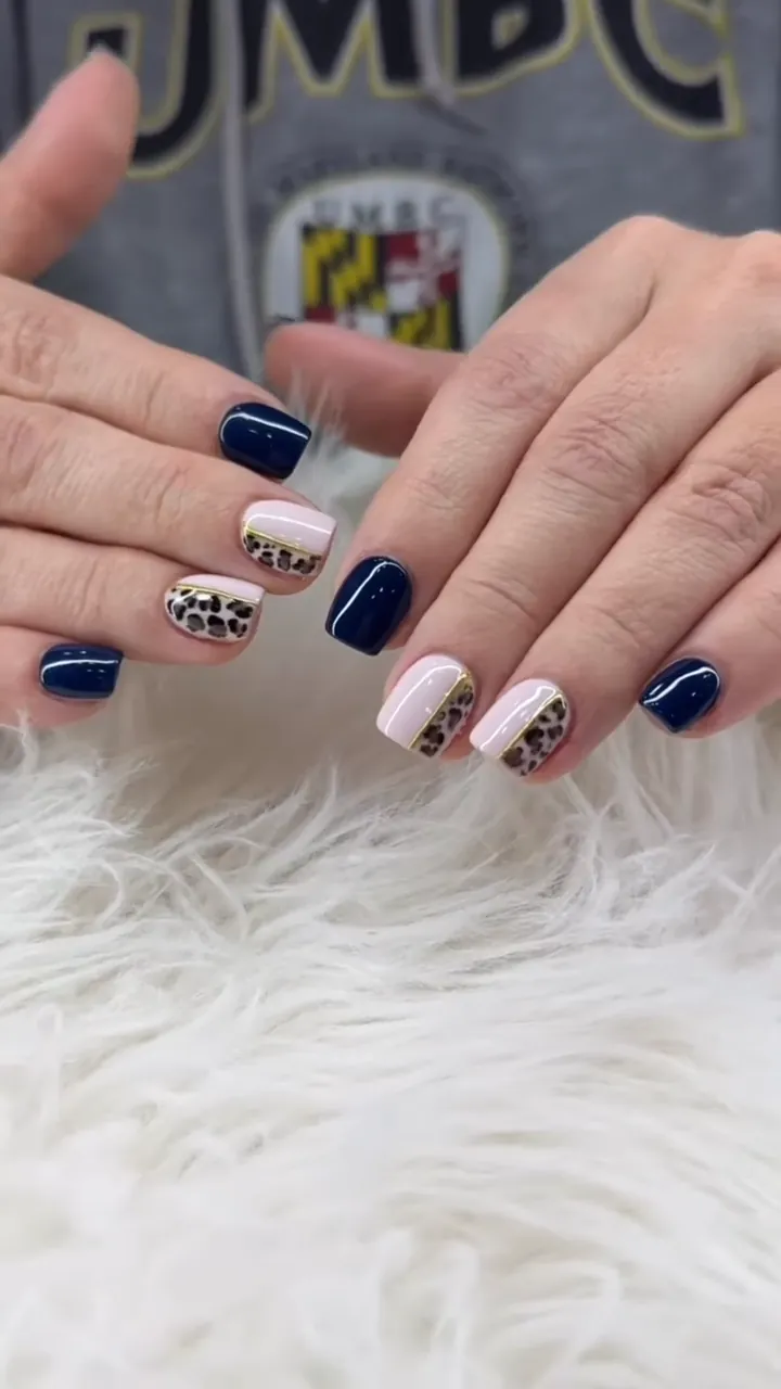 Video of navy blue nails with leopard print accents