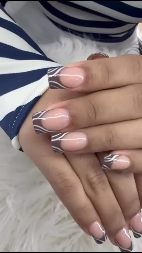 Video of nude nails with white swirl line art