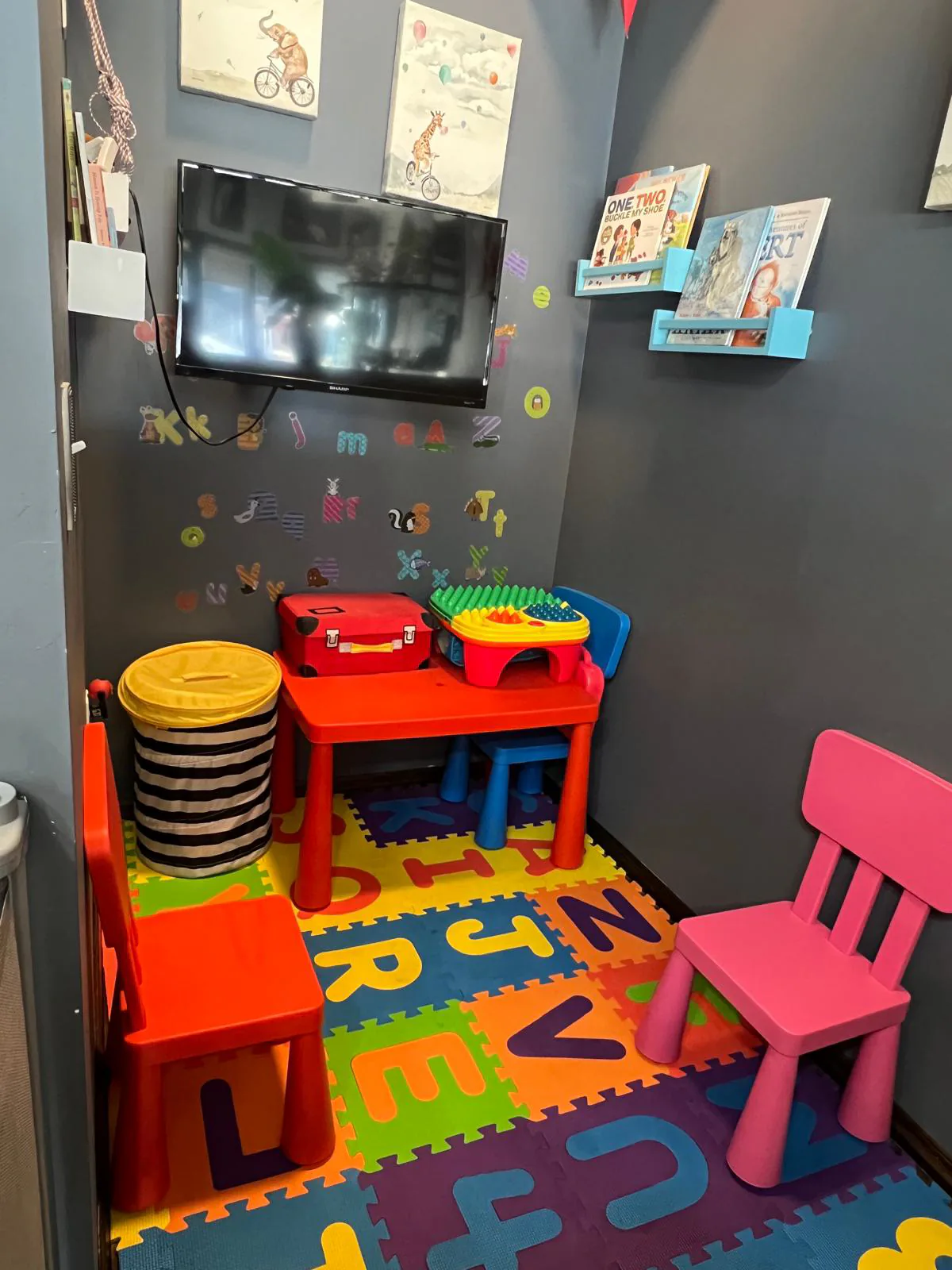 Children's play area with foam mat and toys inside Attraction Nails Salon