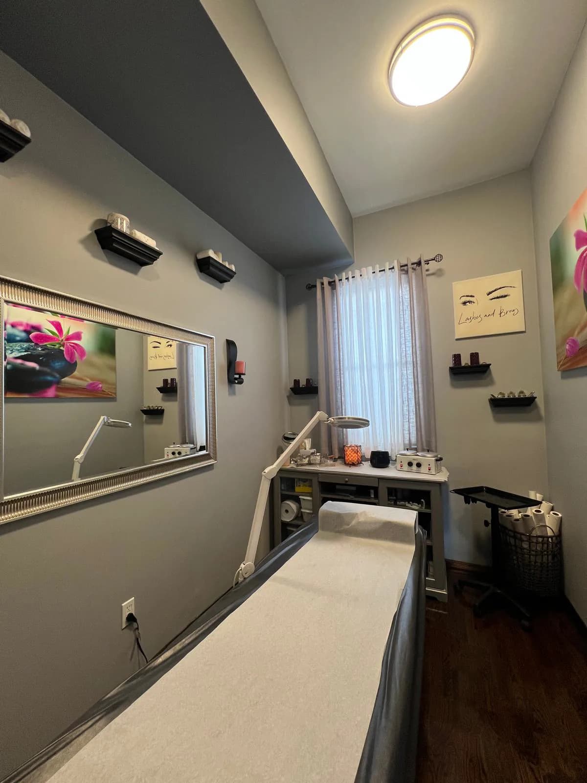 Private waxing treatment room with a treatment bed at Attraction Nails Salon in Roselle Park, NJ