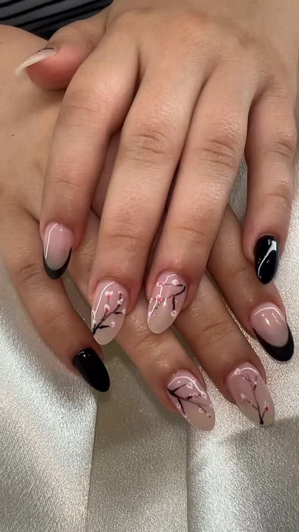 Nude almond nails with black tips and hand-painted line art done at Attraction Nails Salon in Roselle Park, NJ