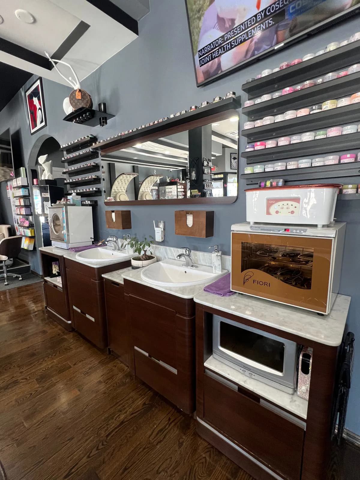 Wash station with sinks and a towel warmer at Attraction Nails Salon
